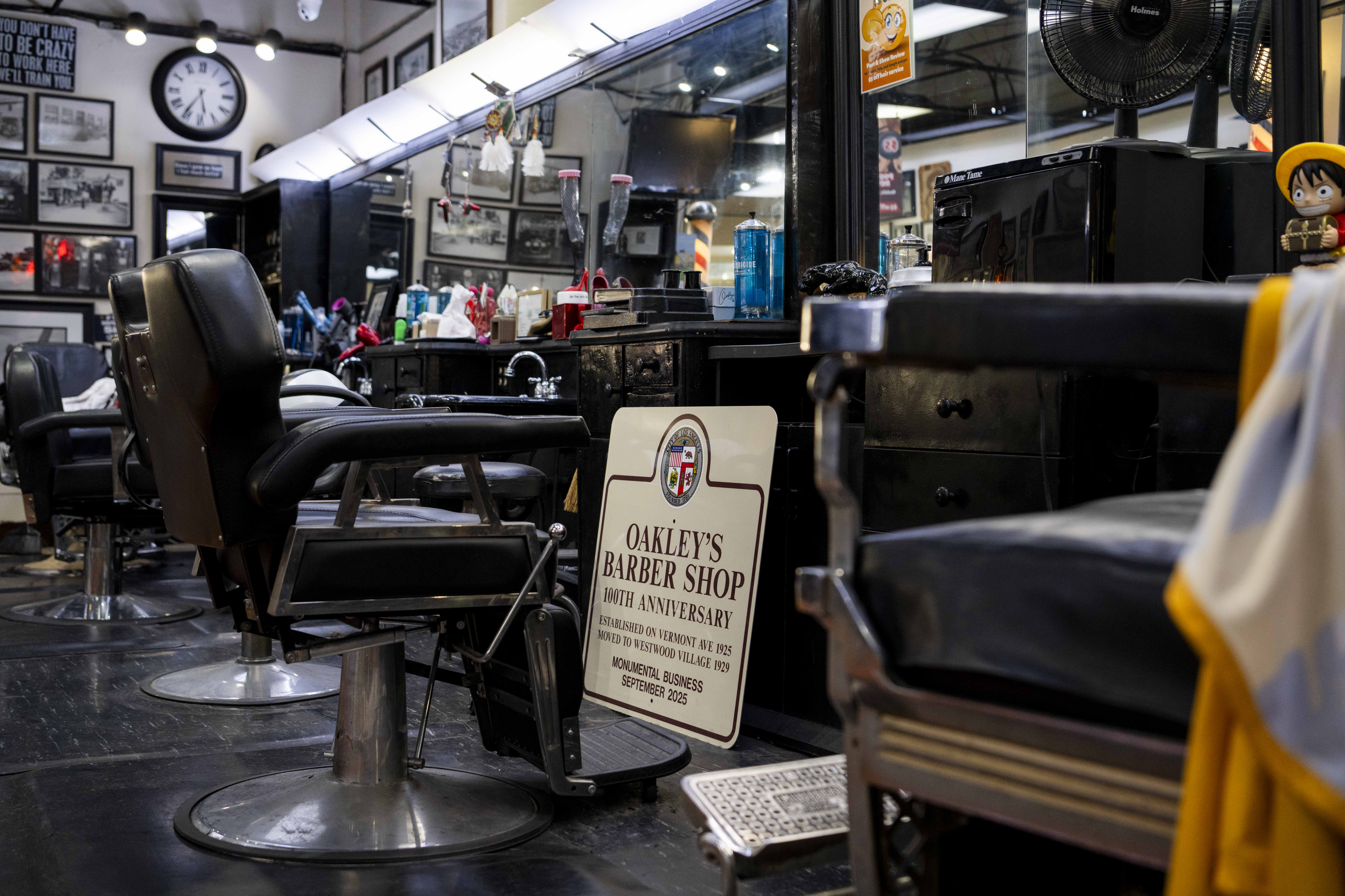 Picture of the chairs and signs inside Oakley’s Barber Shop.